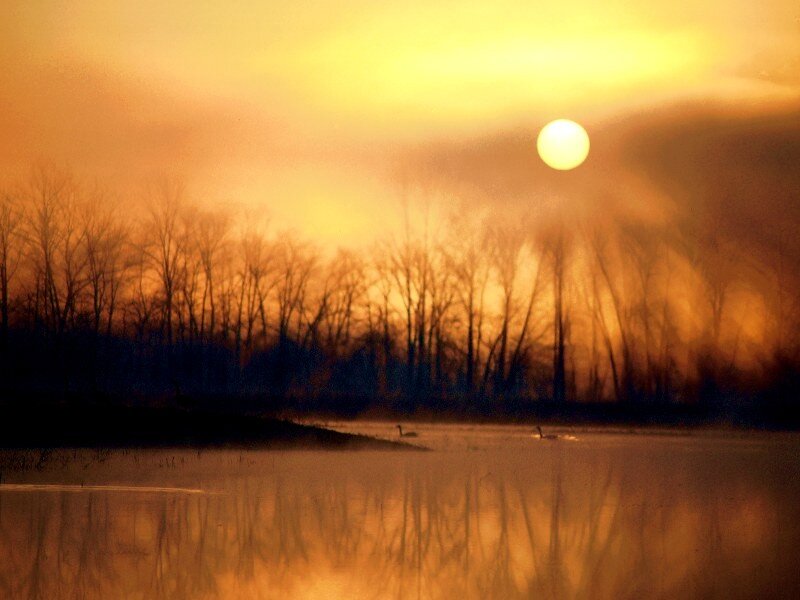 Sunset over a misty lake