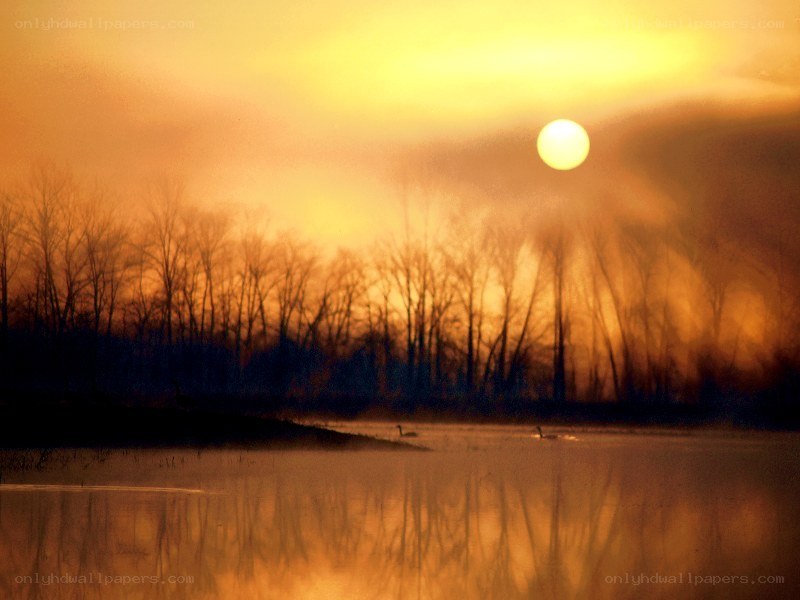 Sunset over a misty lake