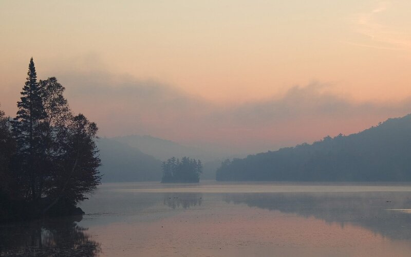 Sunset over a misty lake