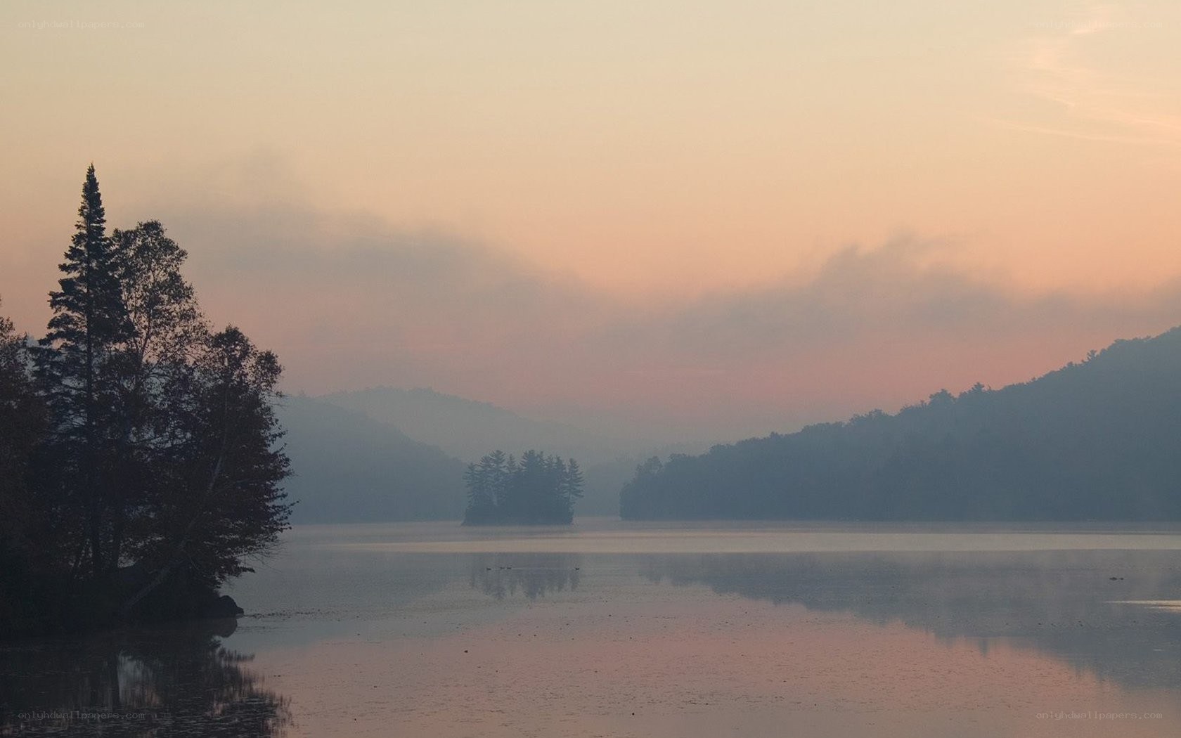Sunset over a misty lake