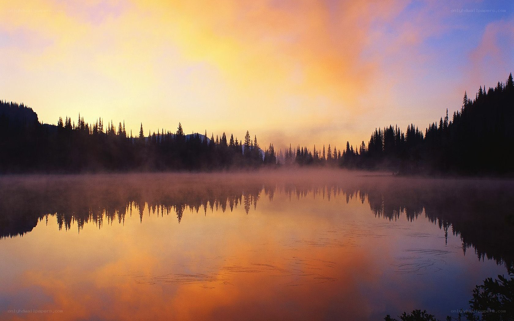 Sunset over a misty lake