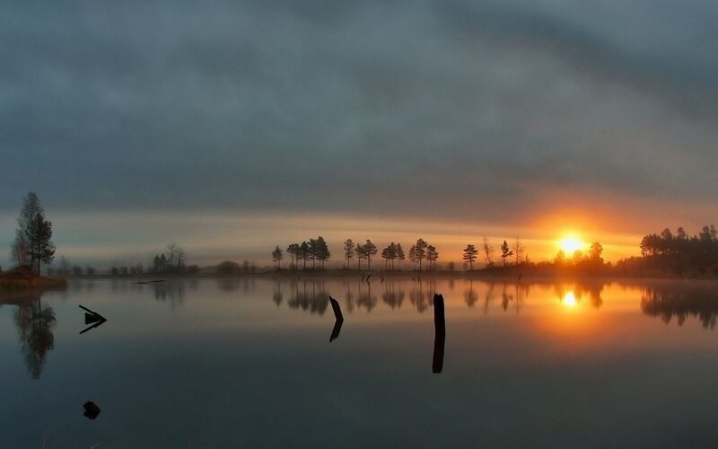Sunset over a misty lake