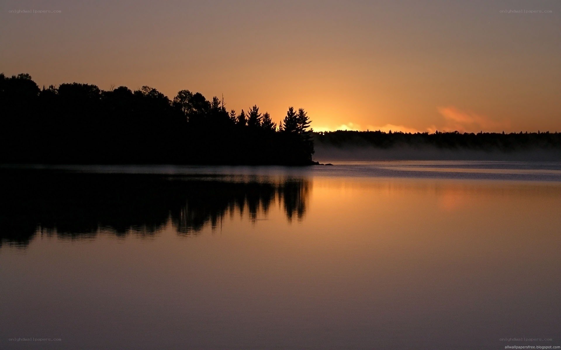 sunset over a misty lake