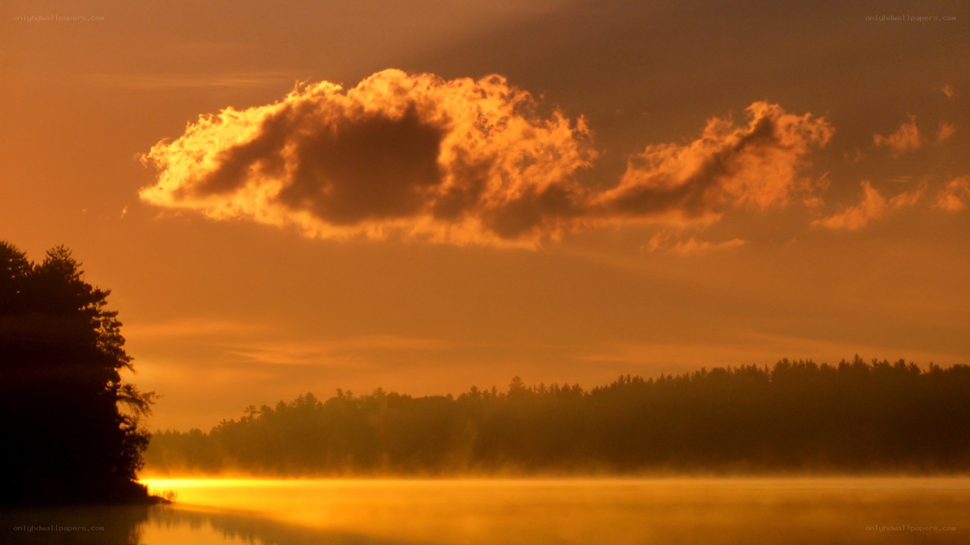 sunset over a misty lake
