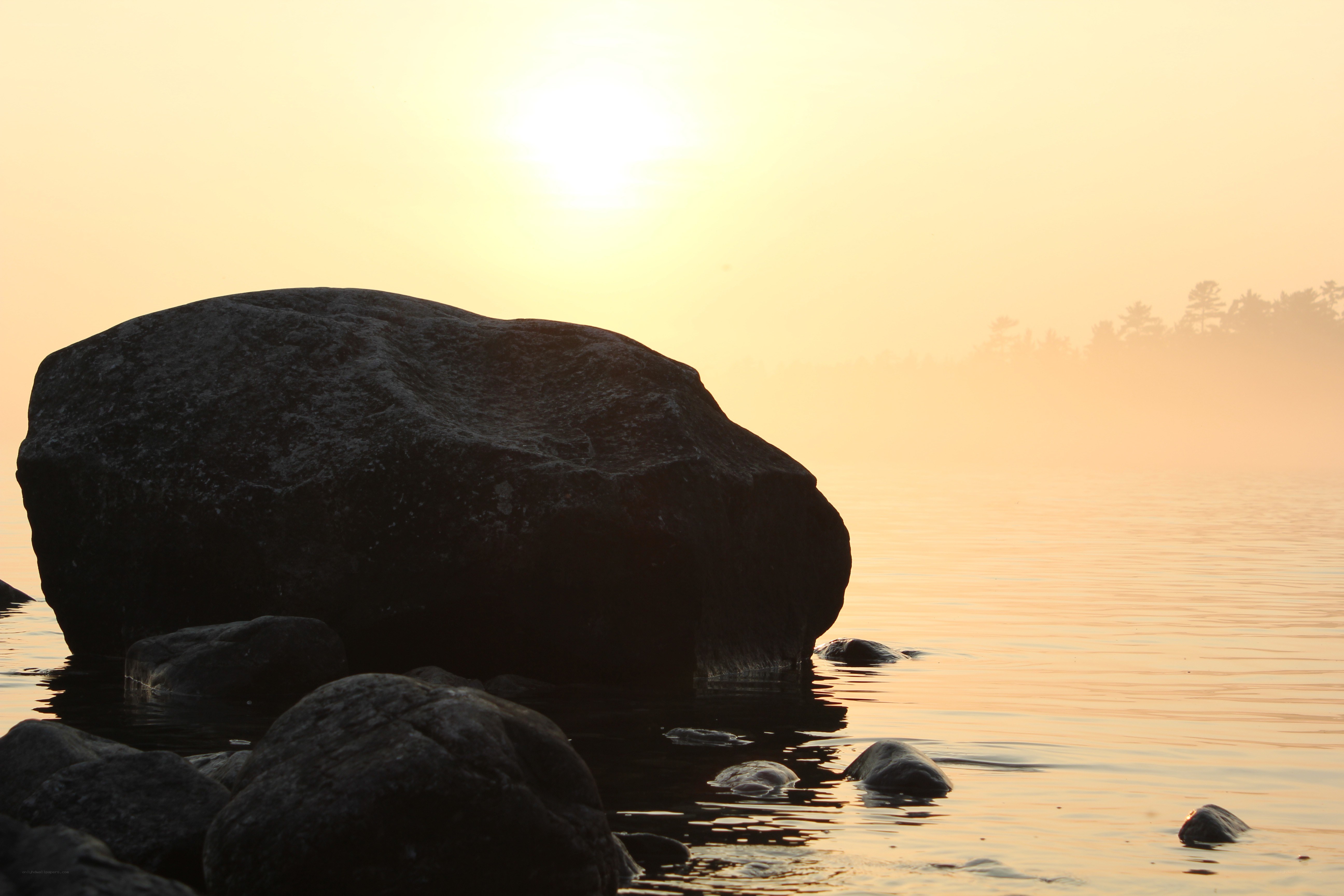 Sunset over a misty lake