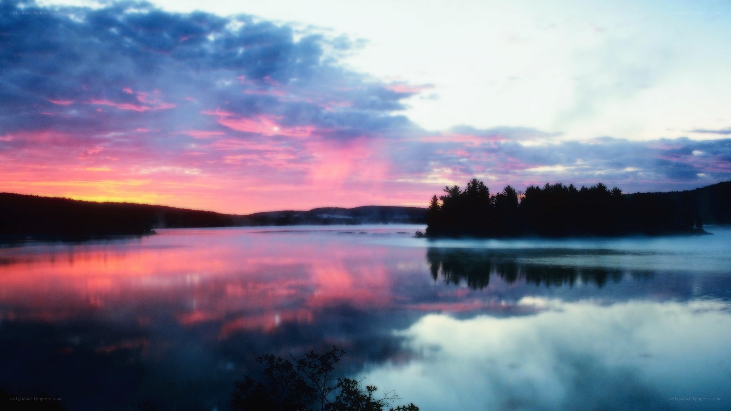 sunset over a misty lake