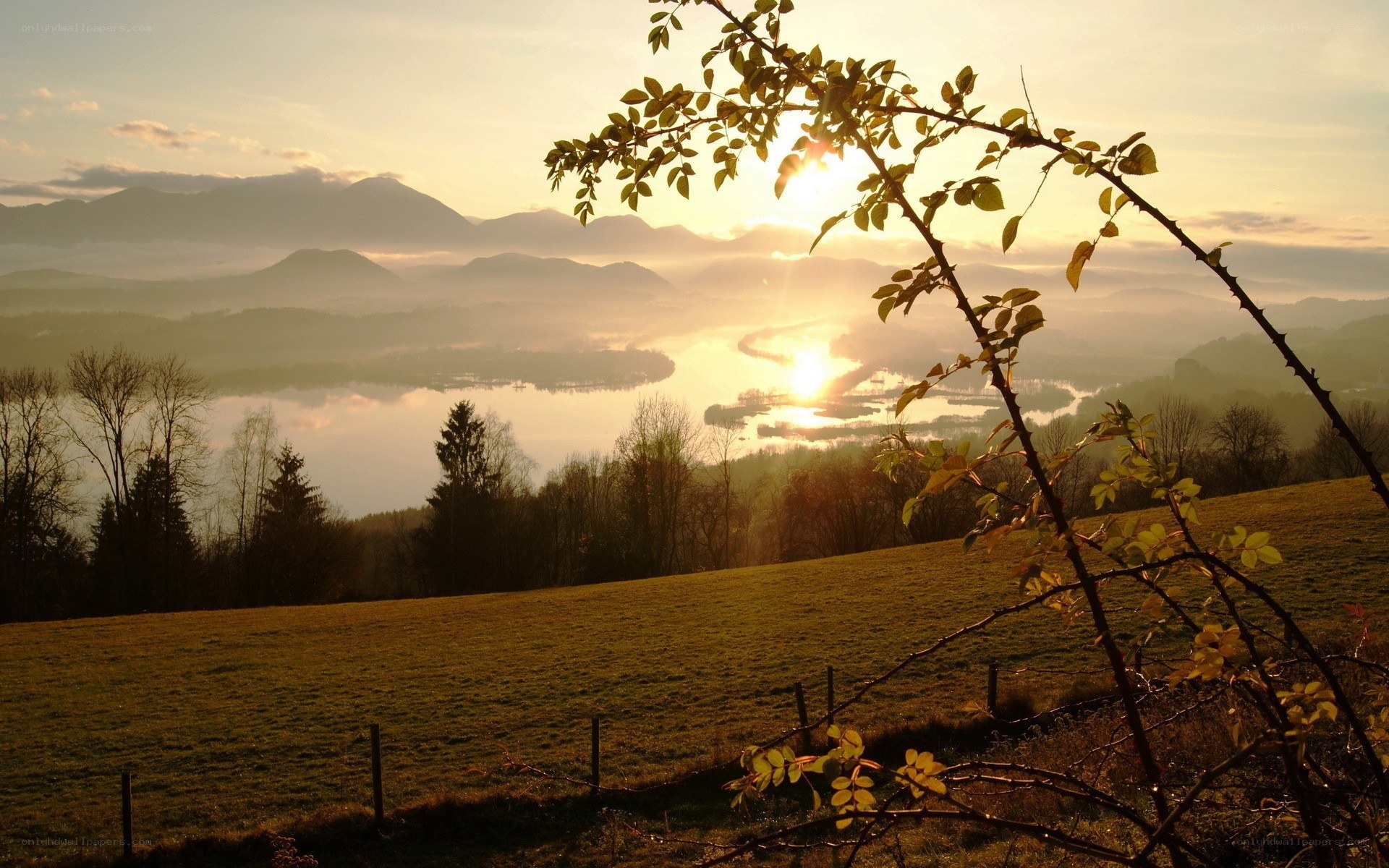 Sunset over a misty lake