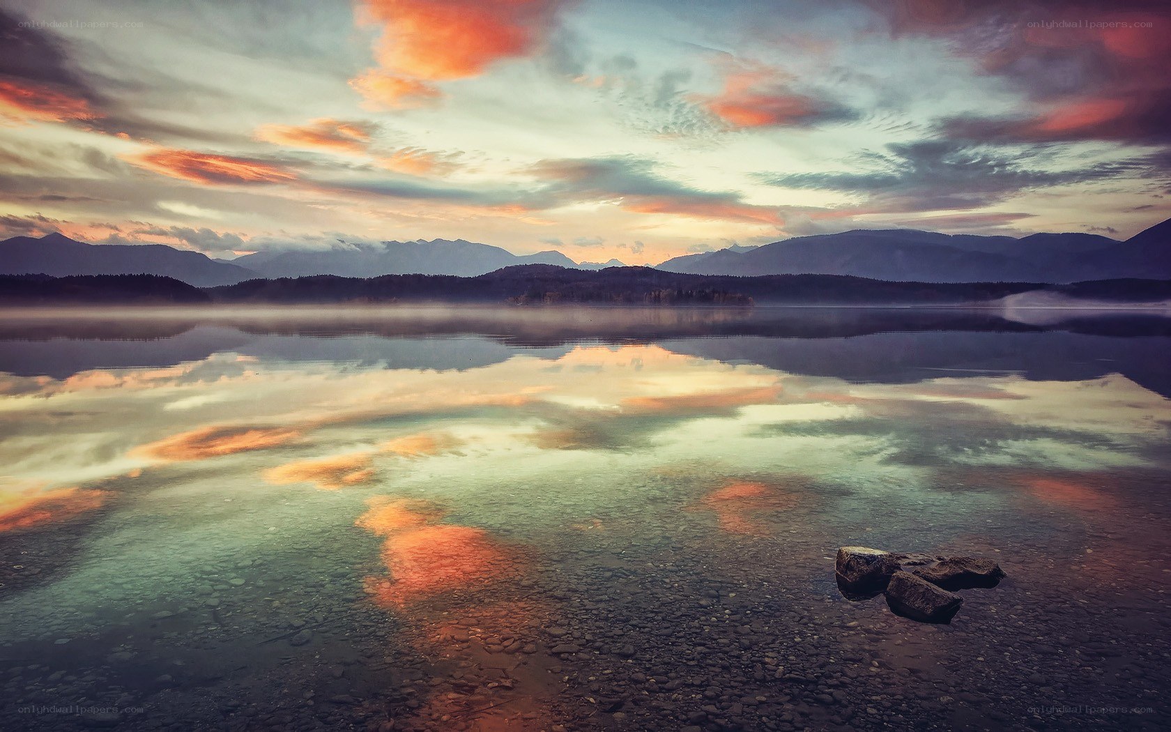 Sunset over a misty lake