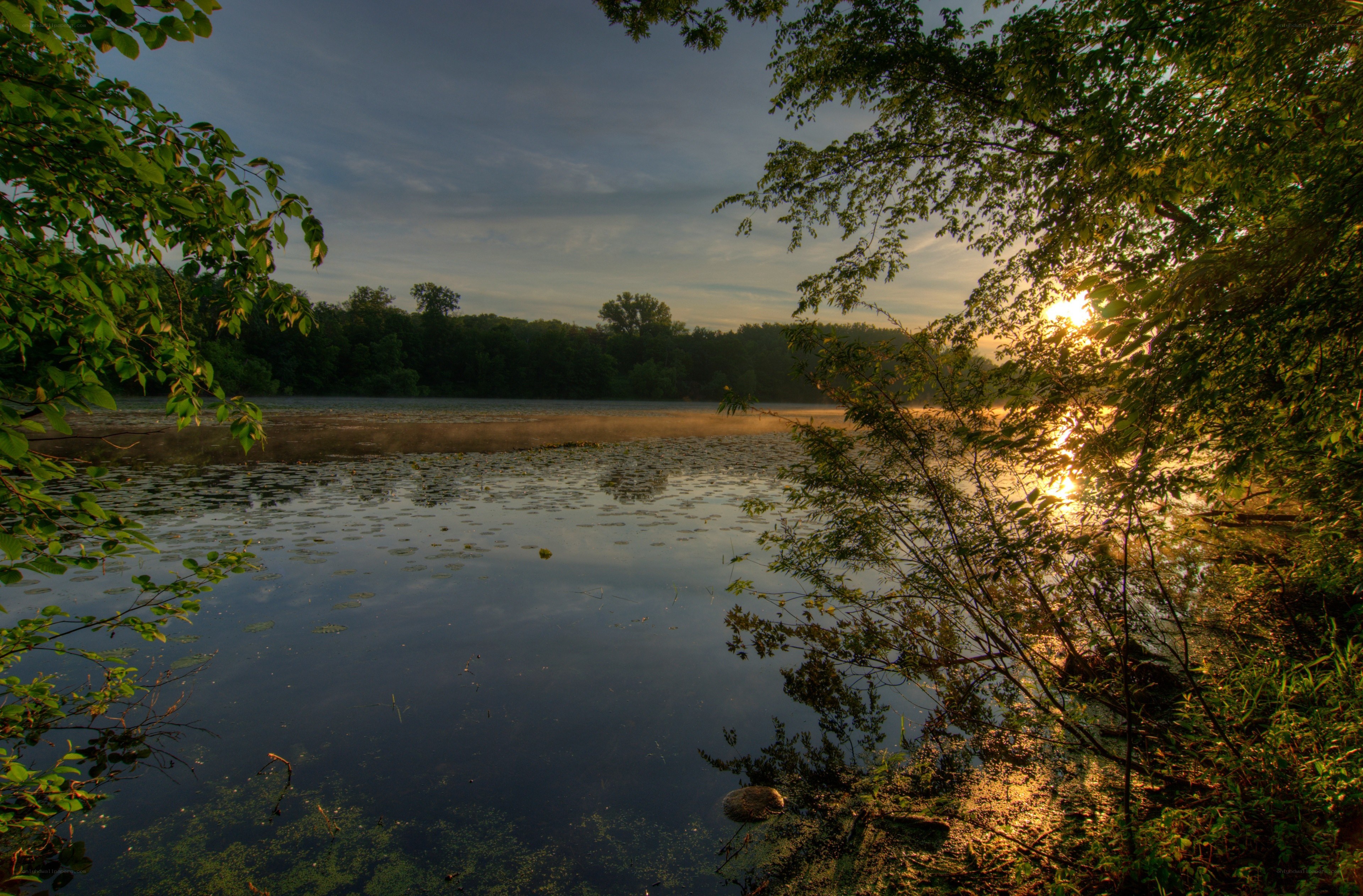 Sunset over a misty lake