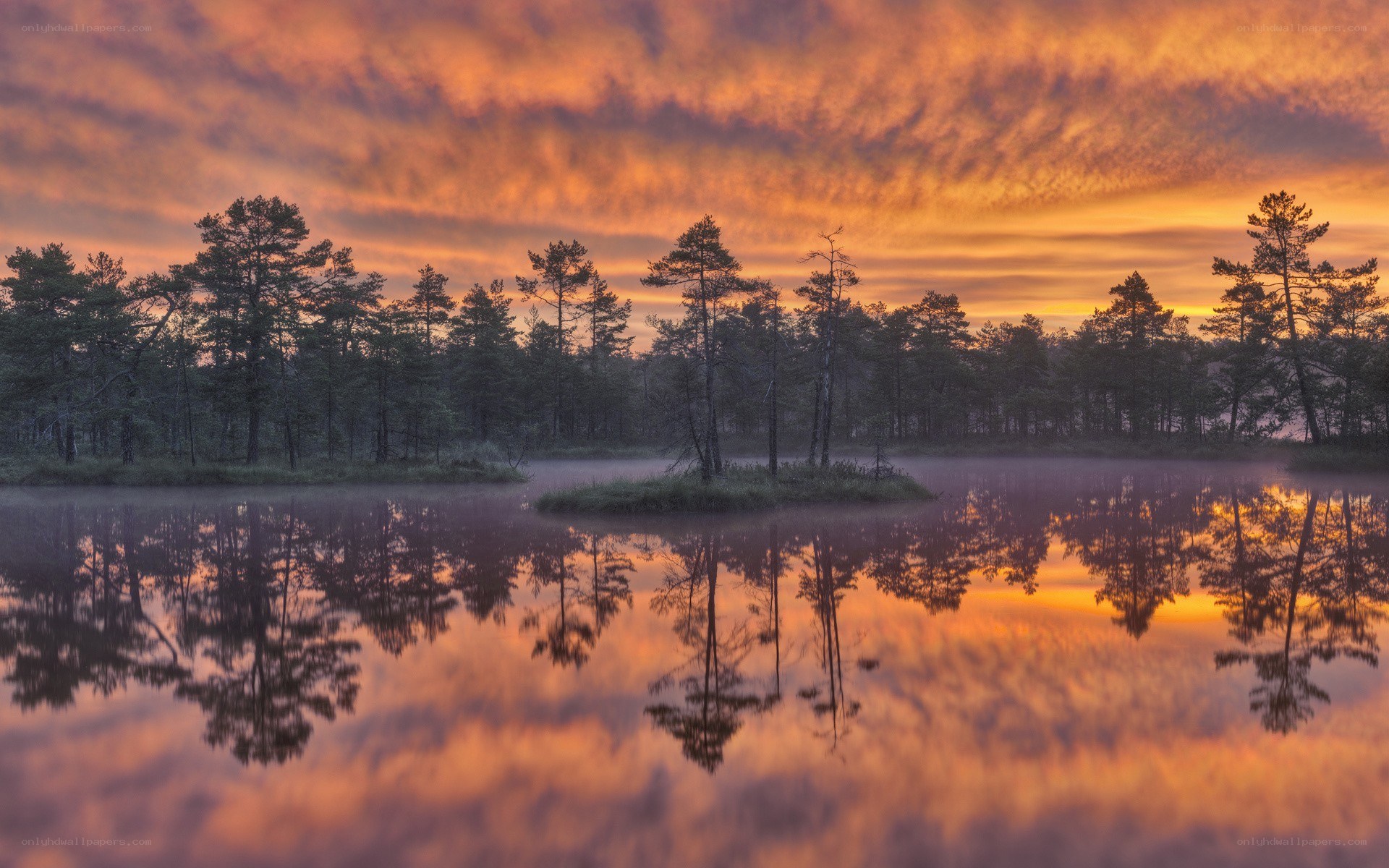 Sunset over a misty lake