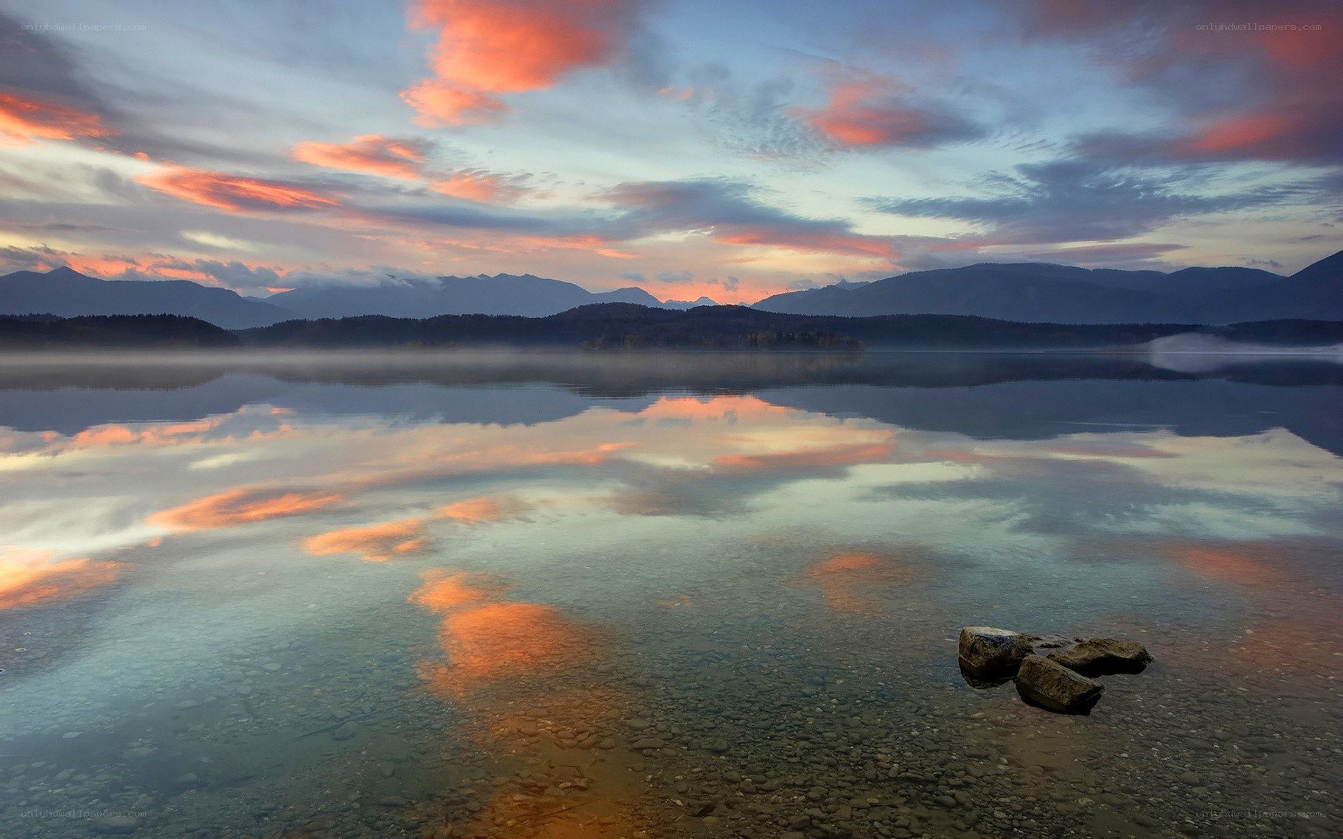 Sunset over a misty lake