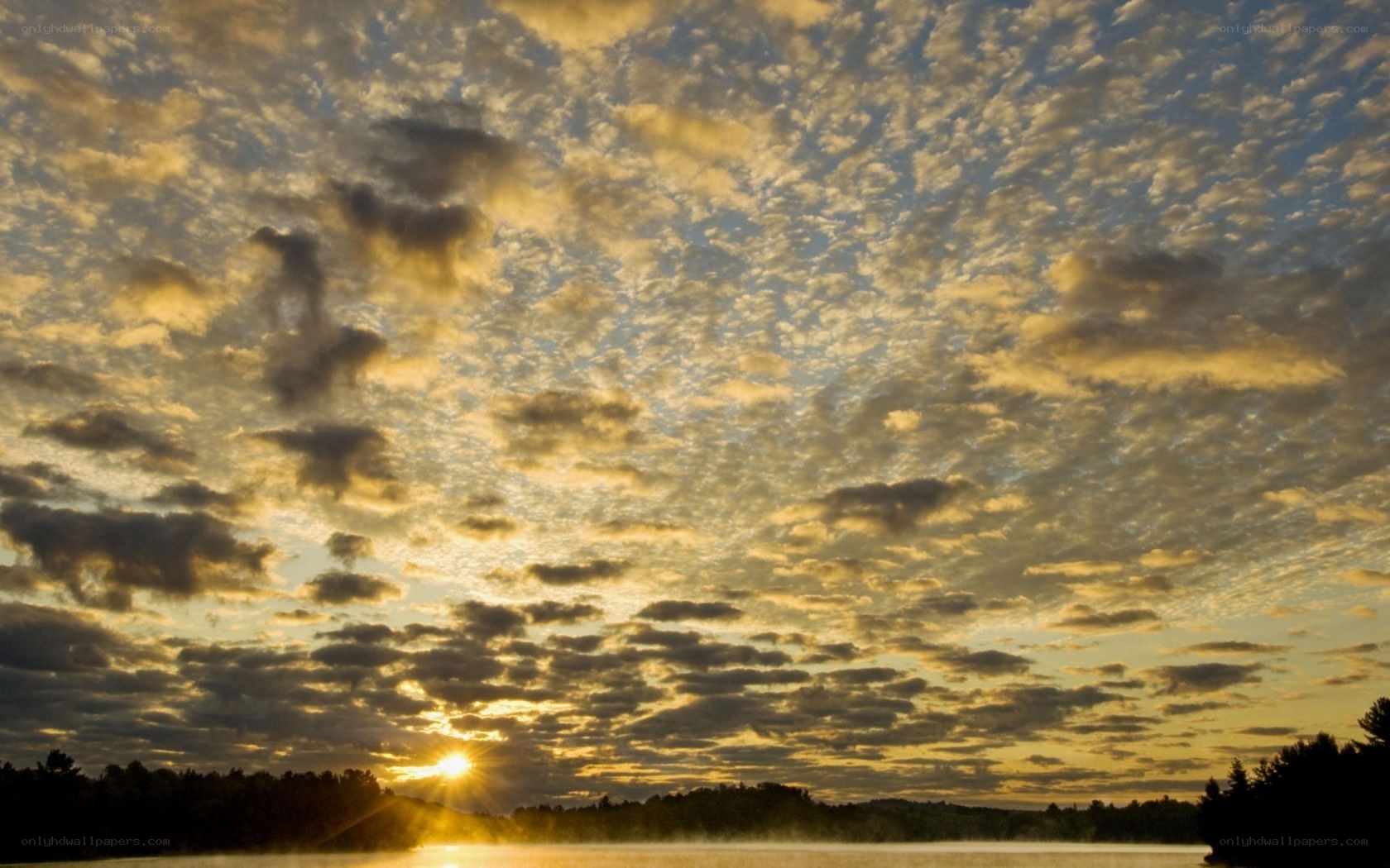 Sunset over a misty lake