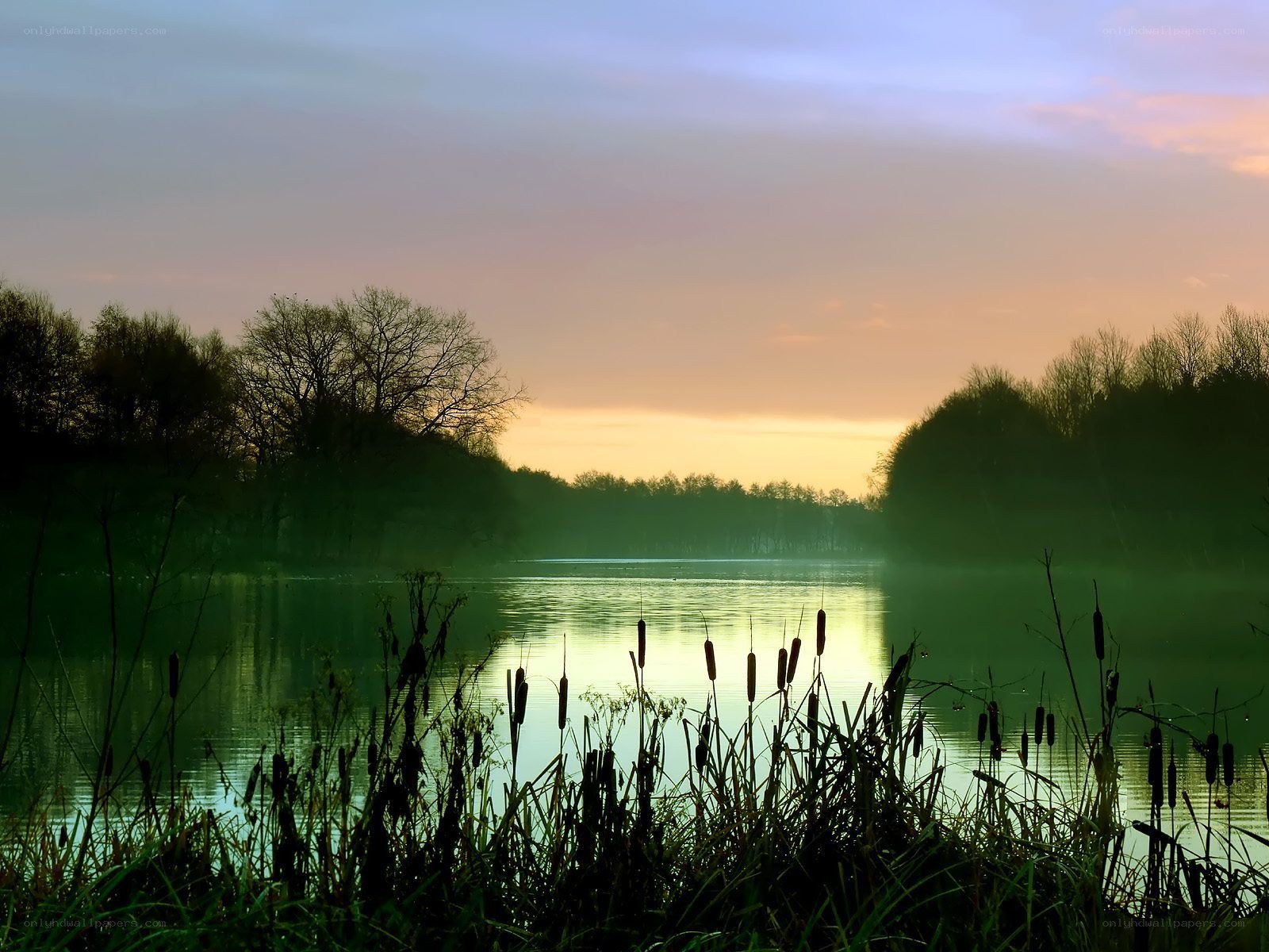 Sunset over a misty lake