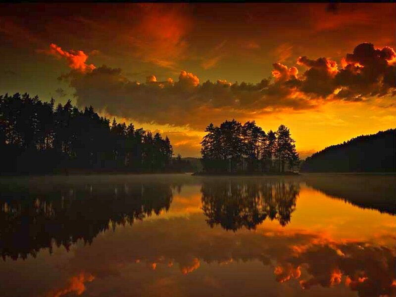 Sunset over a misty lake
