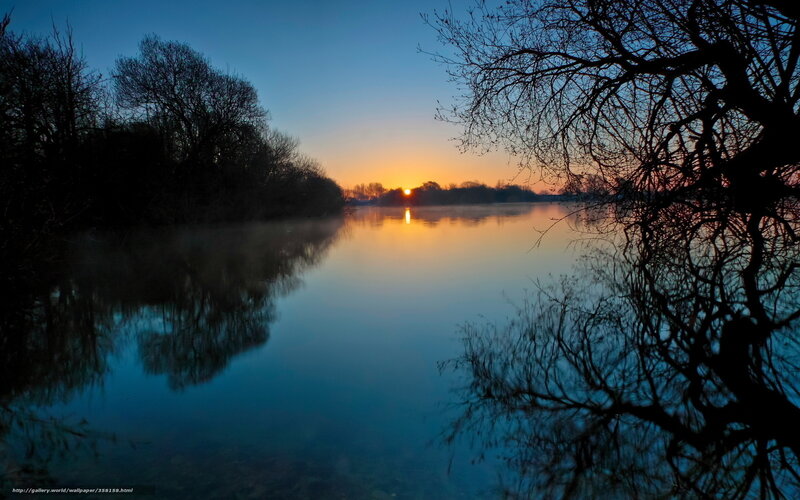 Sunset over a misty lake