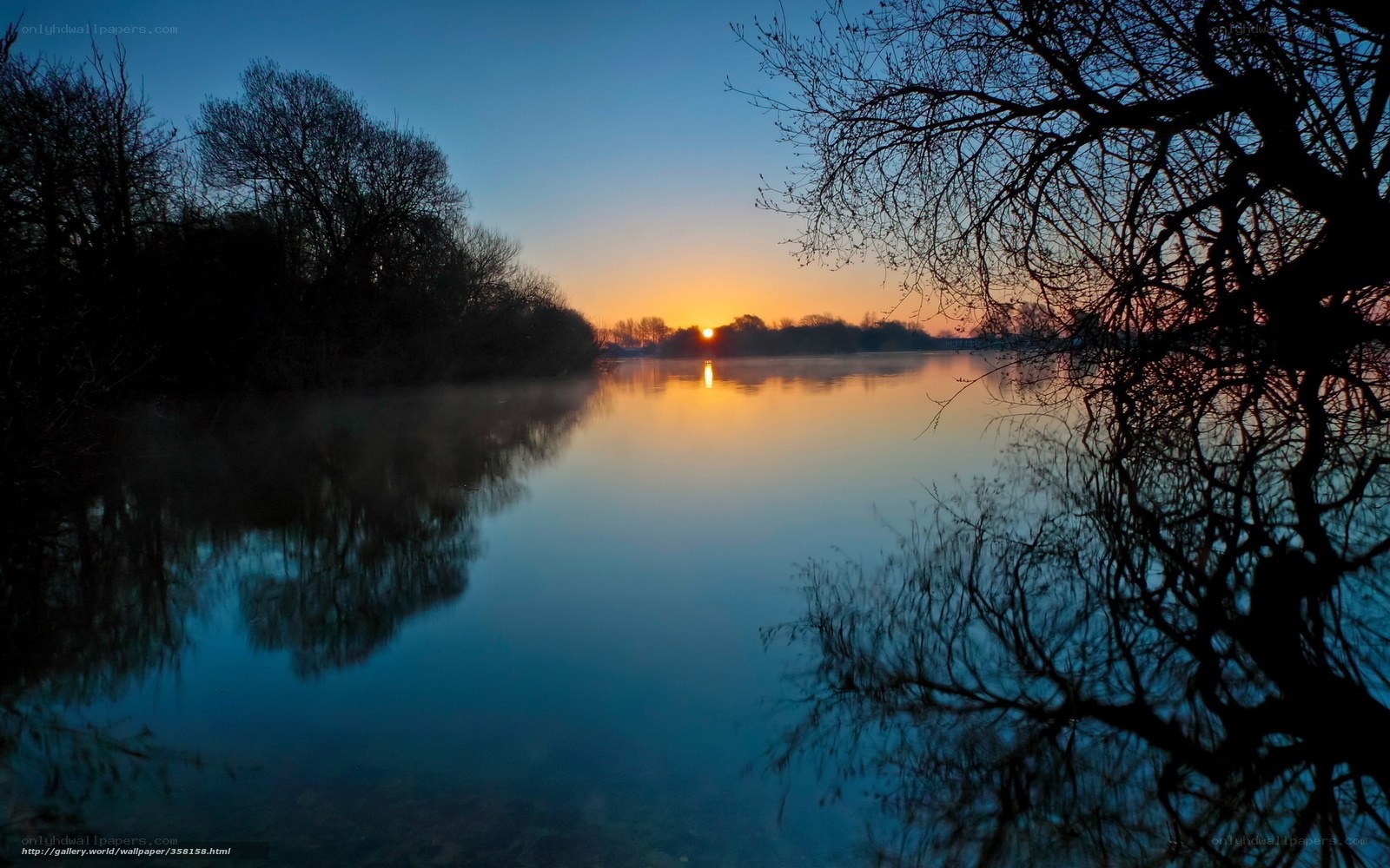 Sunset over a misty lake