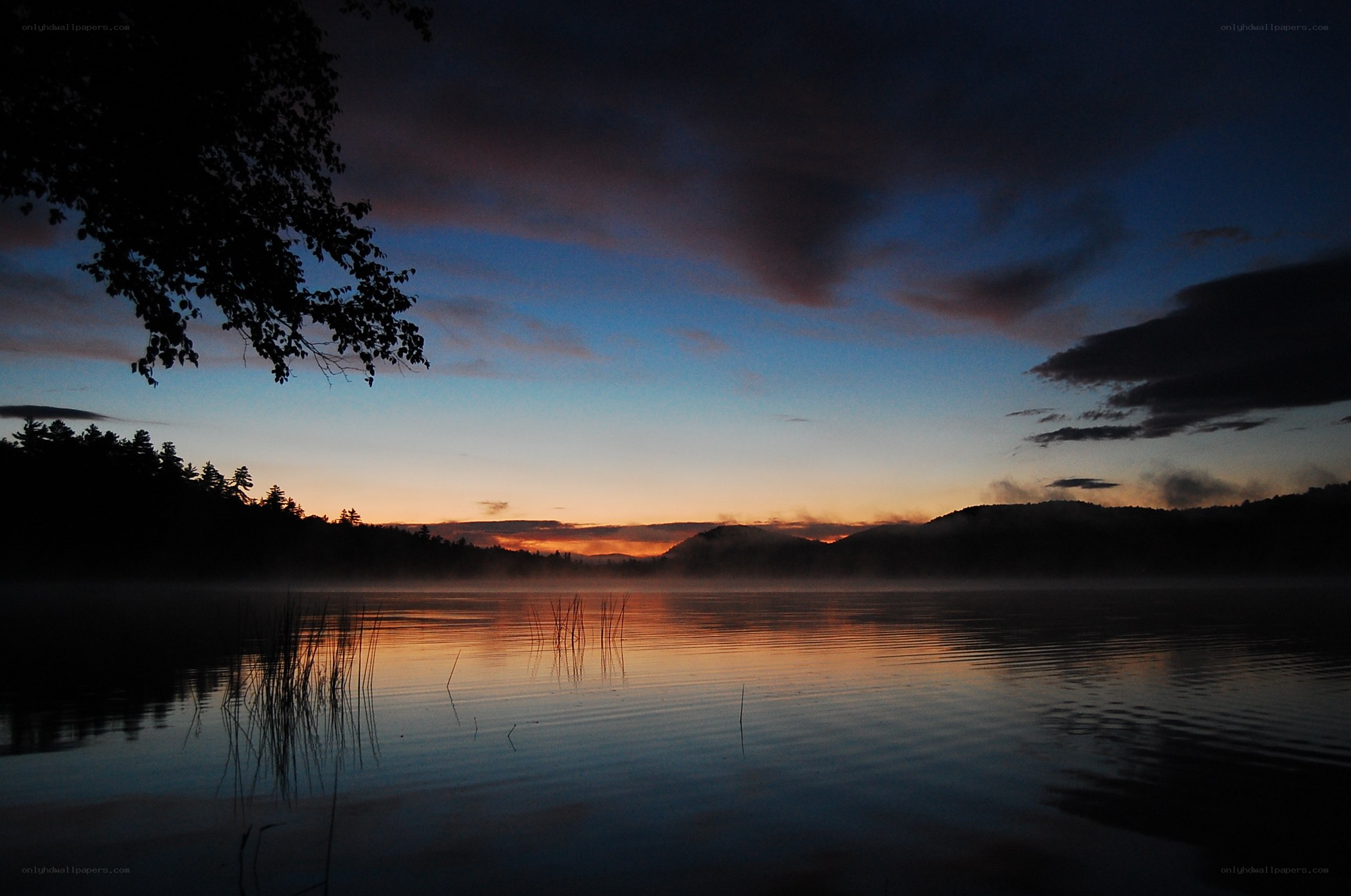 Sunset over a misty lake
