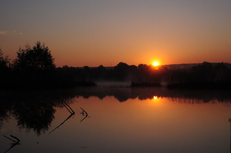 Sunset over a misty lake