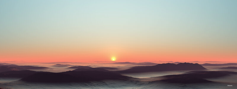 sunset over a misty landscape