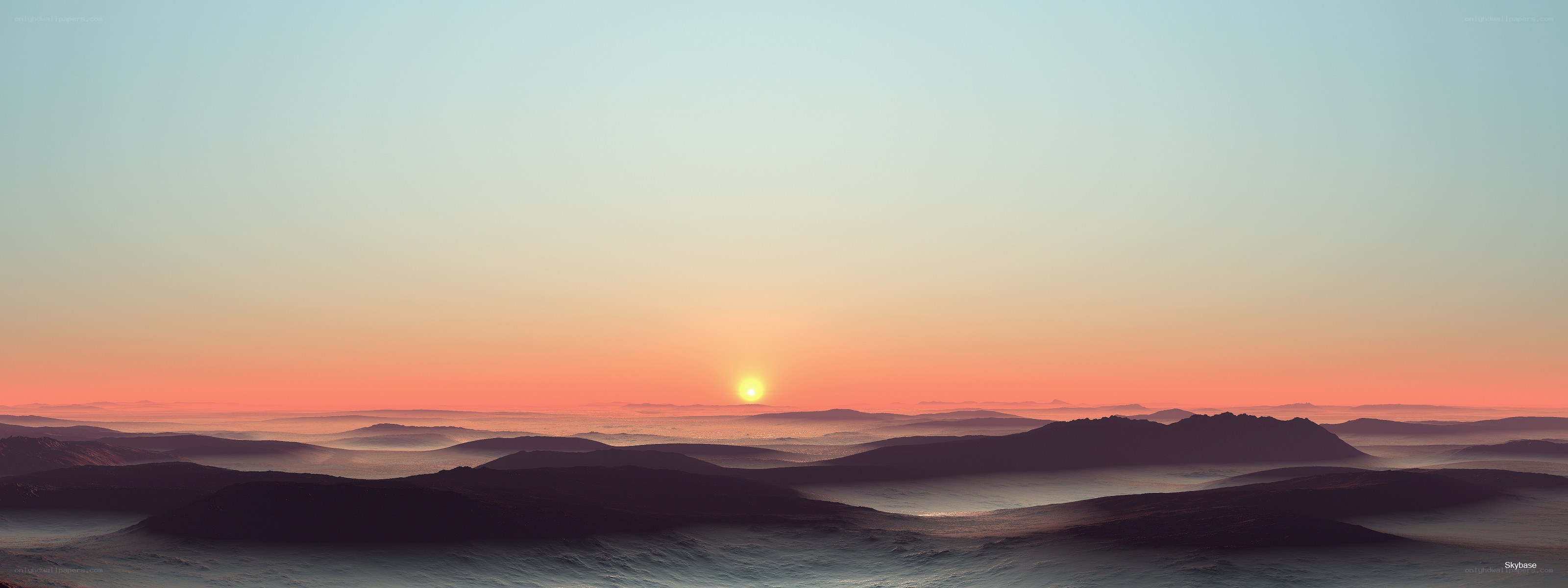 sunset over a misty landscape