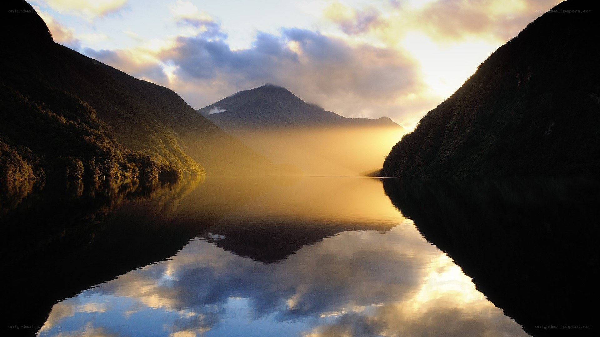 Sunset over a misty mountain lake