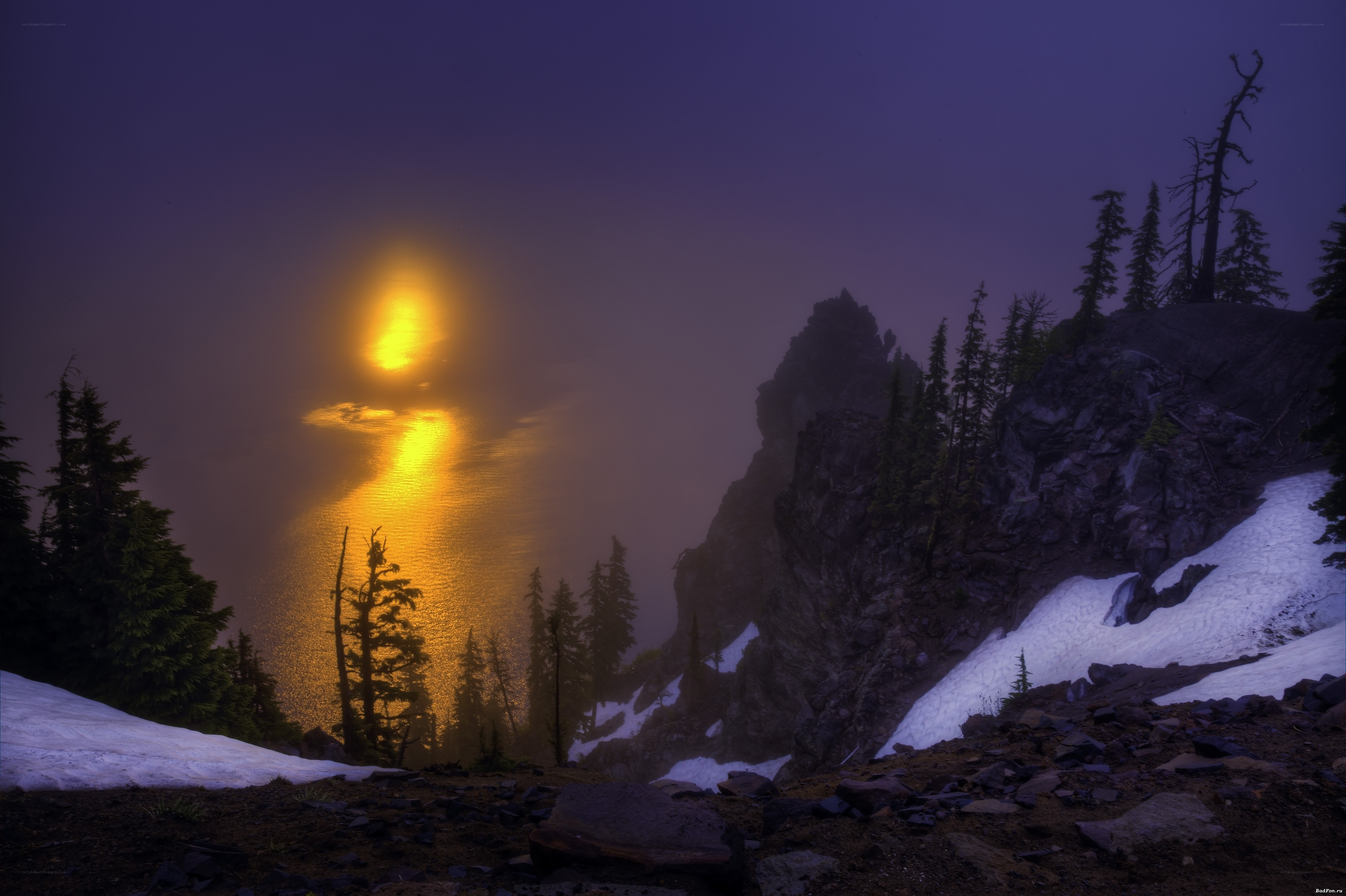 Sunset over a misty mountain lake