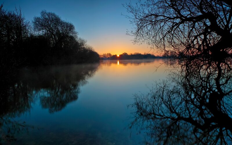 Sunset over a misty river