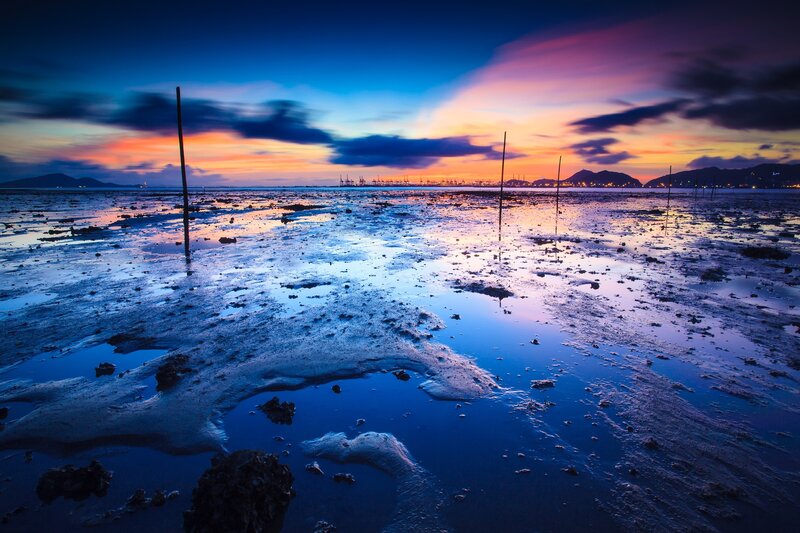 Sunset over a muddy shoreline