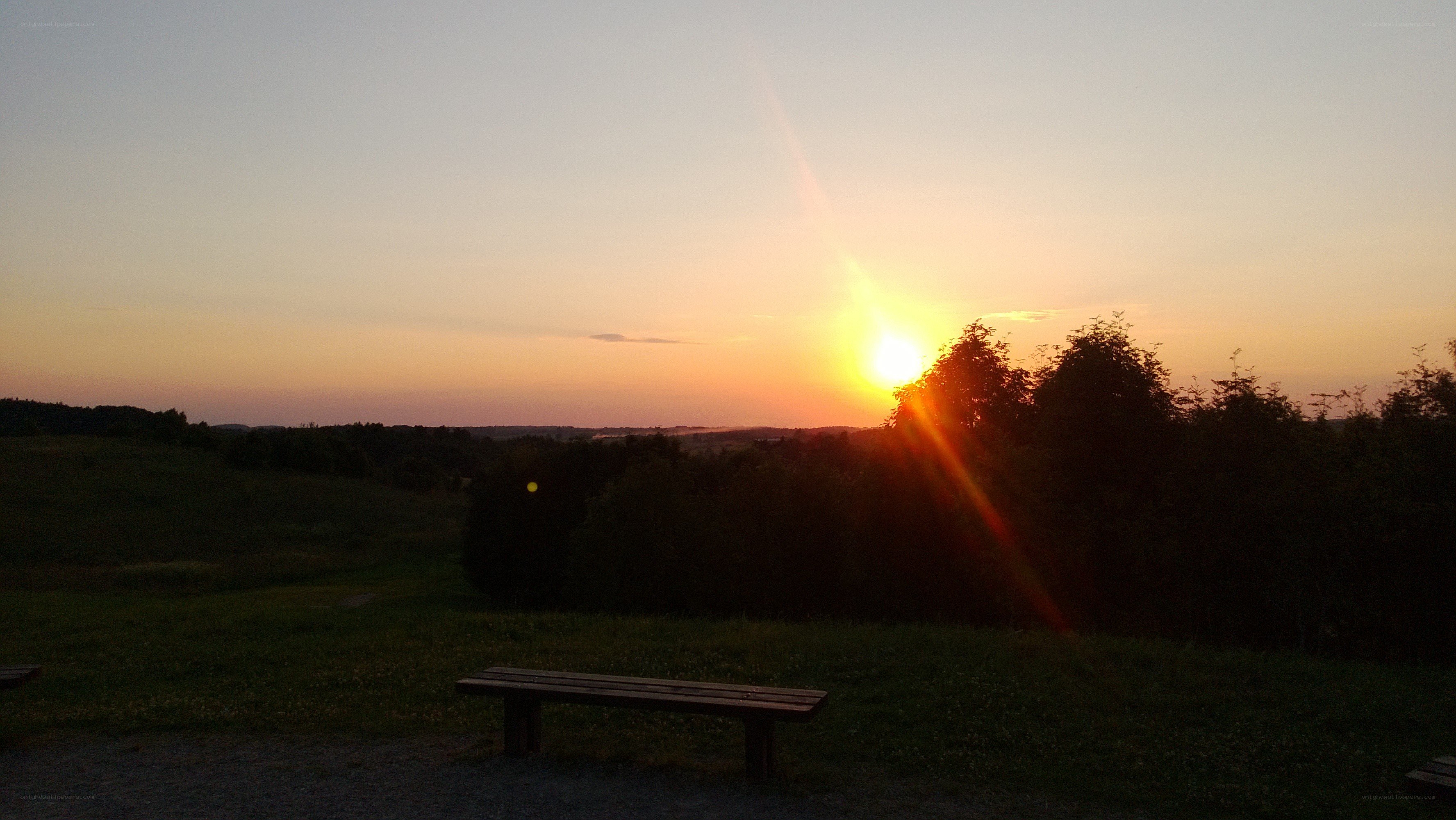 Sunset over a park bench