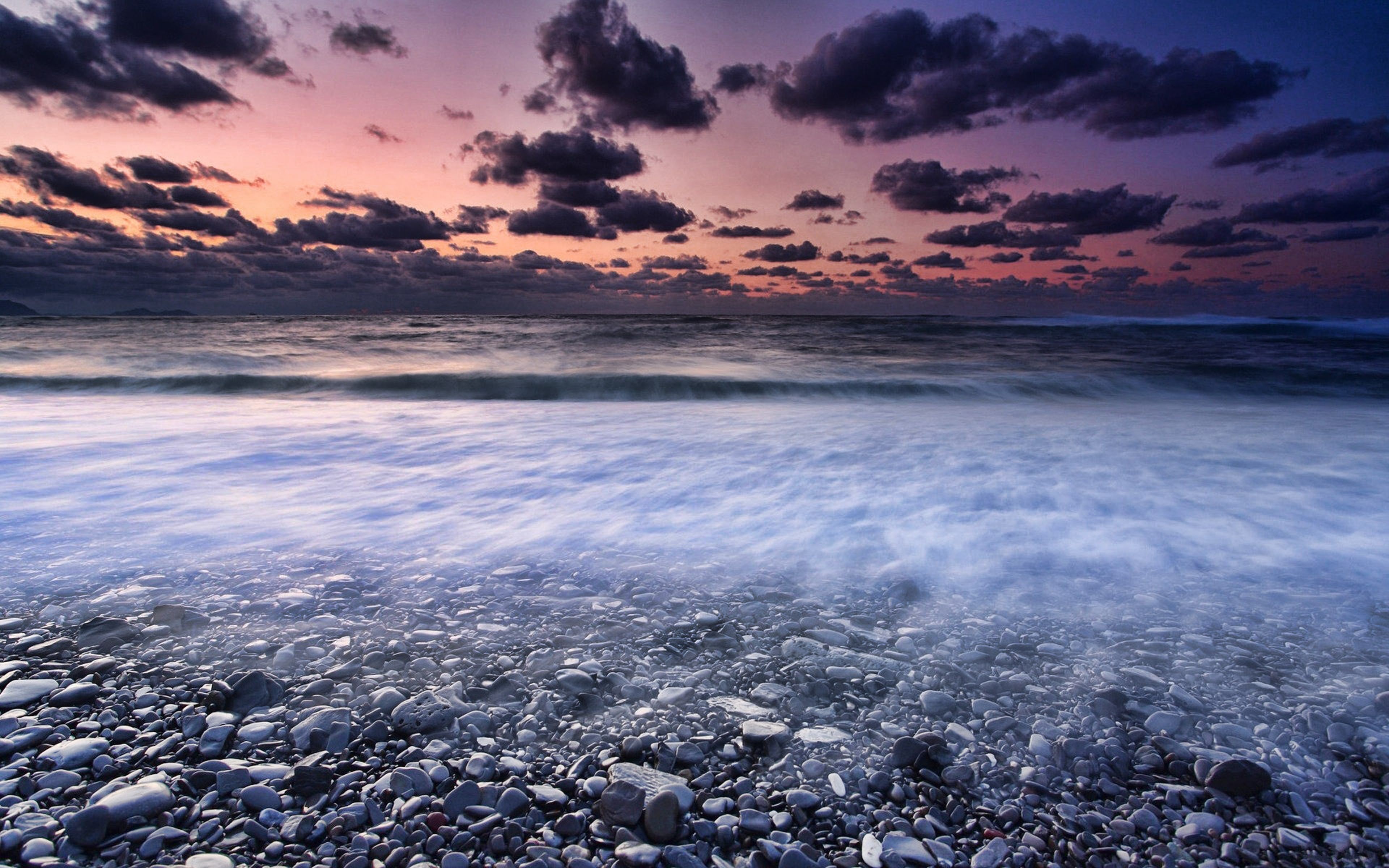 Sunset over a pebble beach