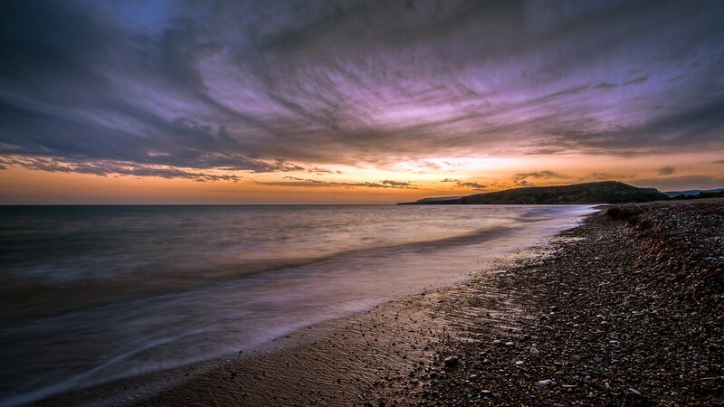 Sunset over a pebble beach