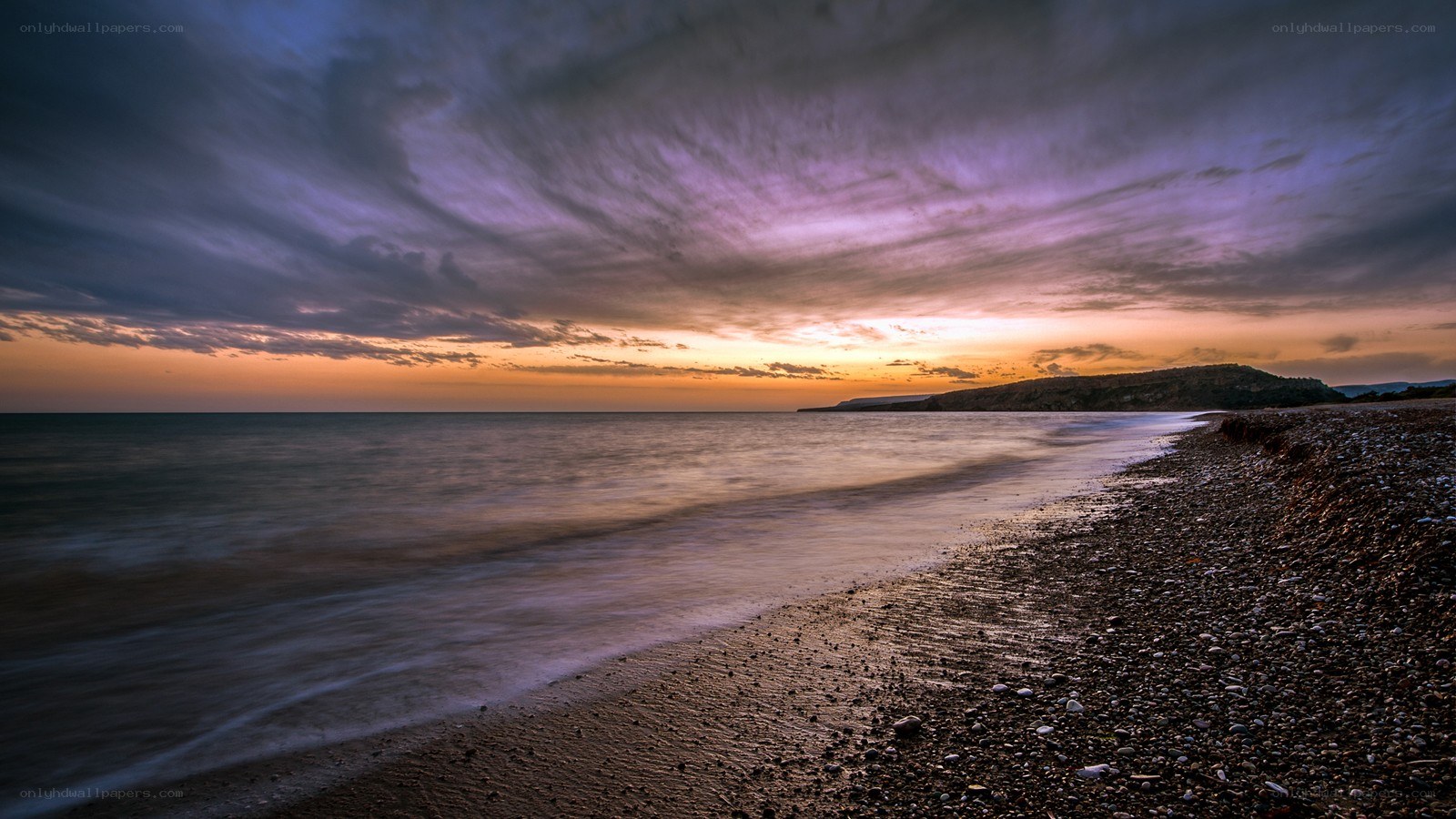 Sunset over a pebble beach