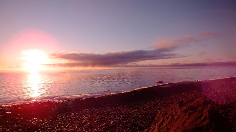 Sunset over a pebble beach