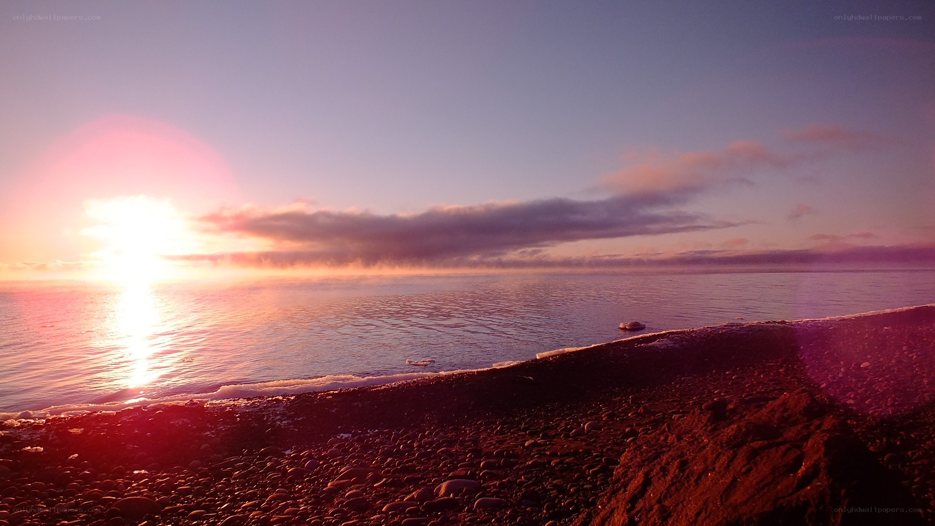 Sunset over a pebble beach