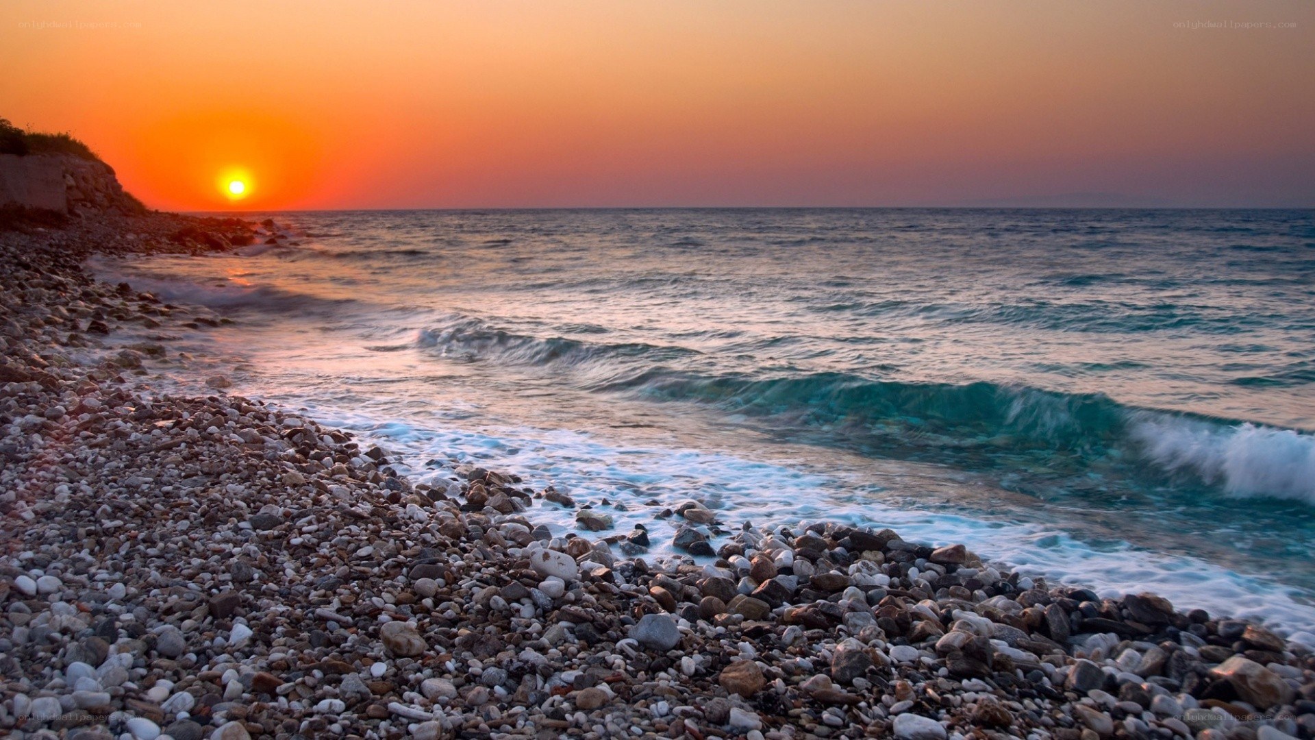 Sunset over a pebble beach