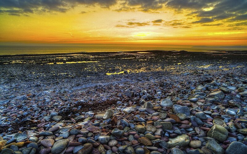 Sunset over a pebble beach