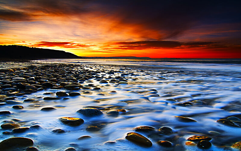 Sunset over a pebble beach