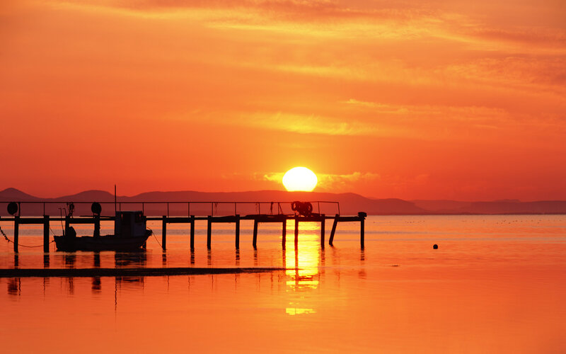 Sunset over a Pier — Orange, Serene