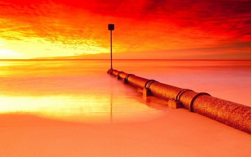 Sunset over a pipe jetty