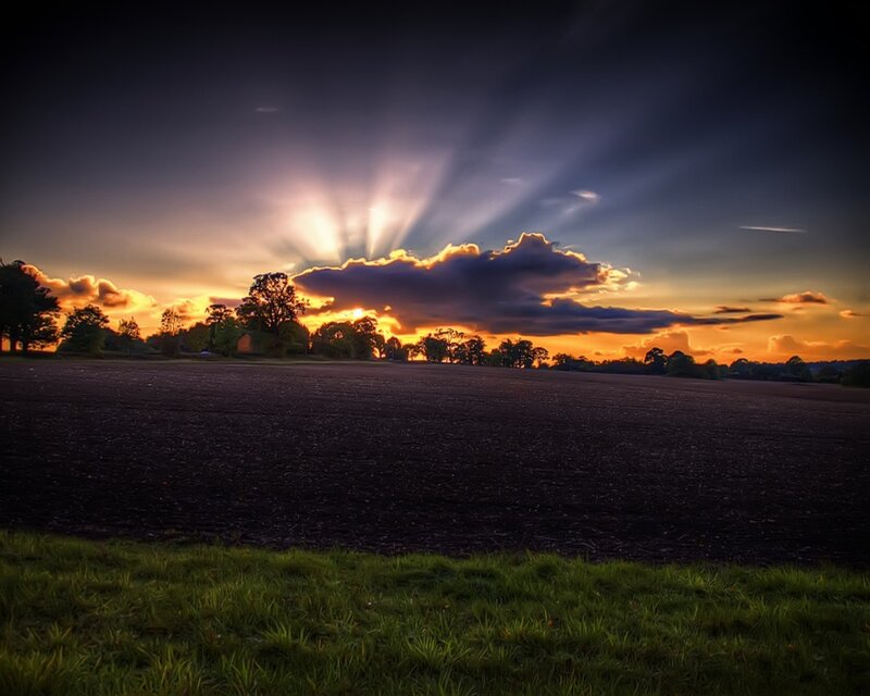 Sunset over a plowed field