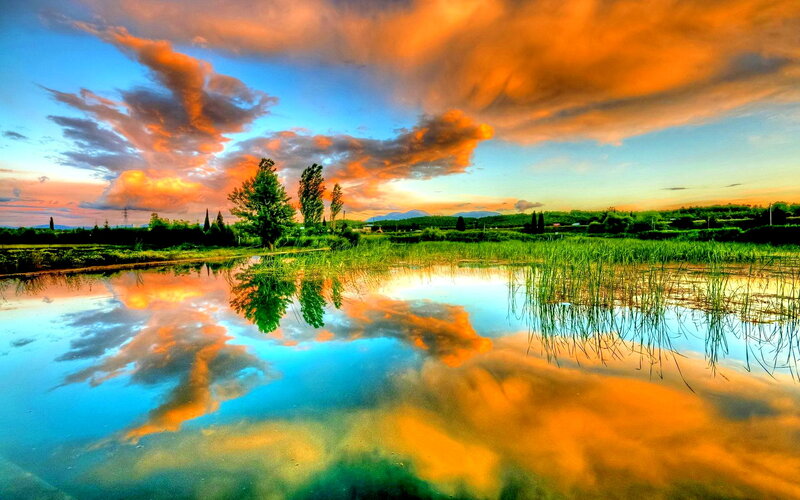 Sunset over a Pond — Orange, Dramatic, Photograph, Clouds, Trees, Mountains