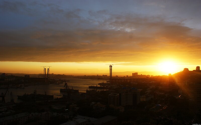 Sunset over a port city