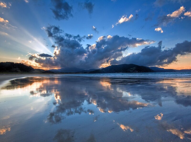 Sunset over a reflective beach