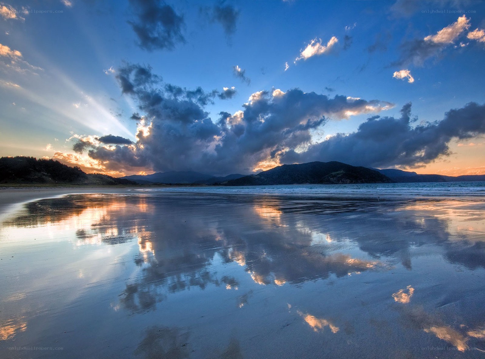 Sunset over a reflective beach