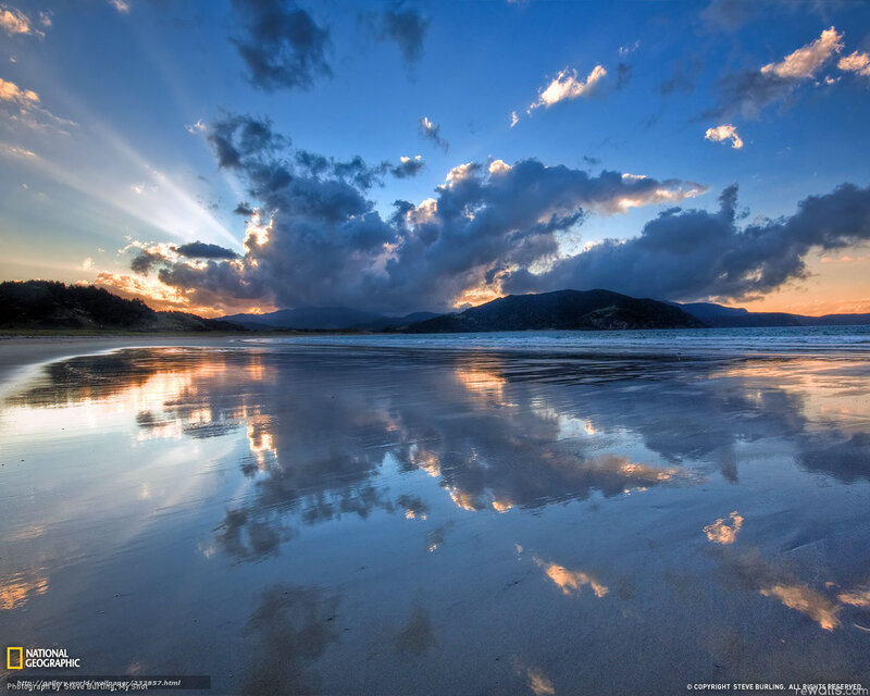 Sunset over a reflective beach