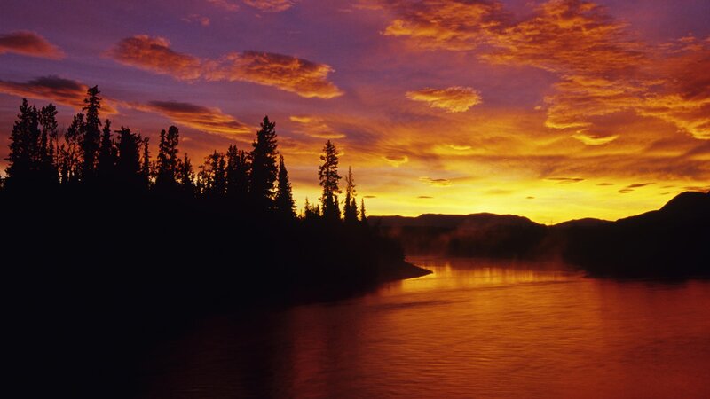 sunset over a river and forest