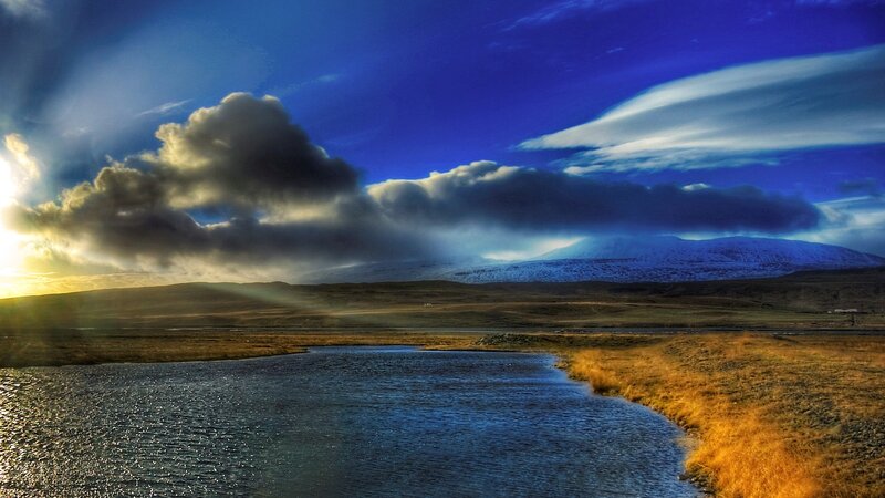 Sunset over a river and mountains