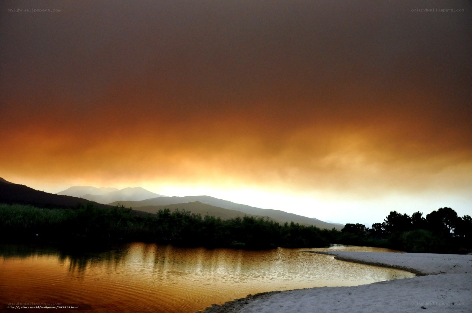 Sunset over a river and mountains
