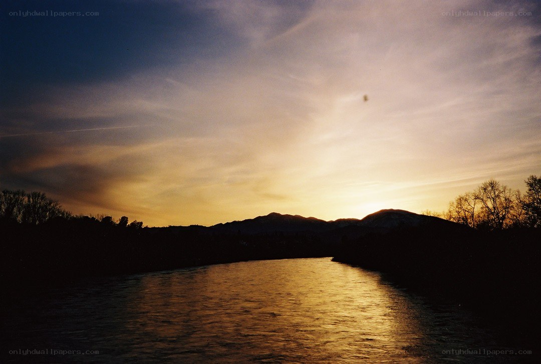 Sunset over a river at dusk