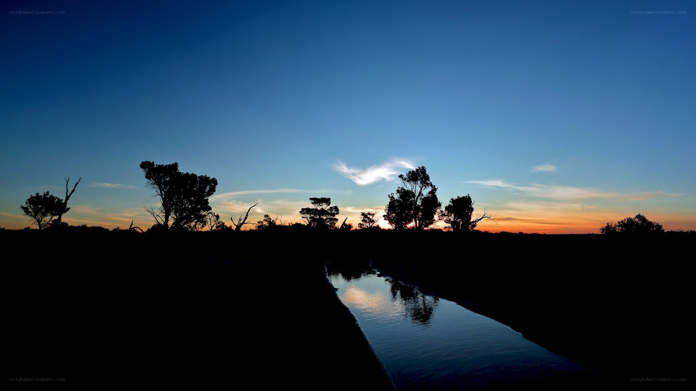 sunset over a river at dusk